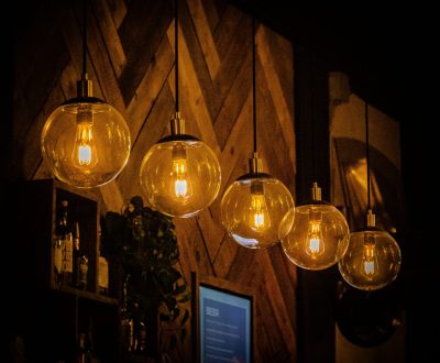 A row of decorative light bulbs hanging in a cafe